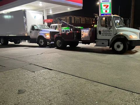 Dawson Tow Service wrecker towing a box truck in Dallas, TX
