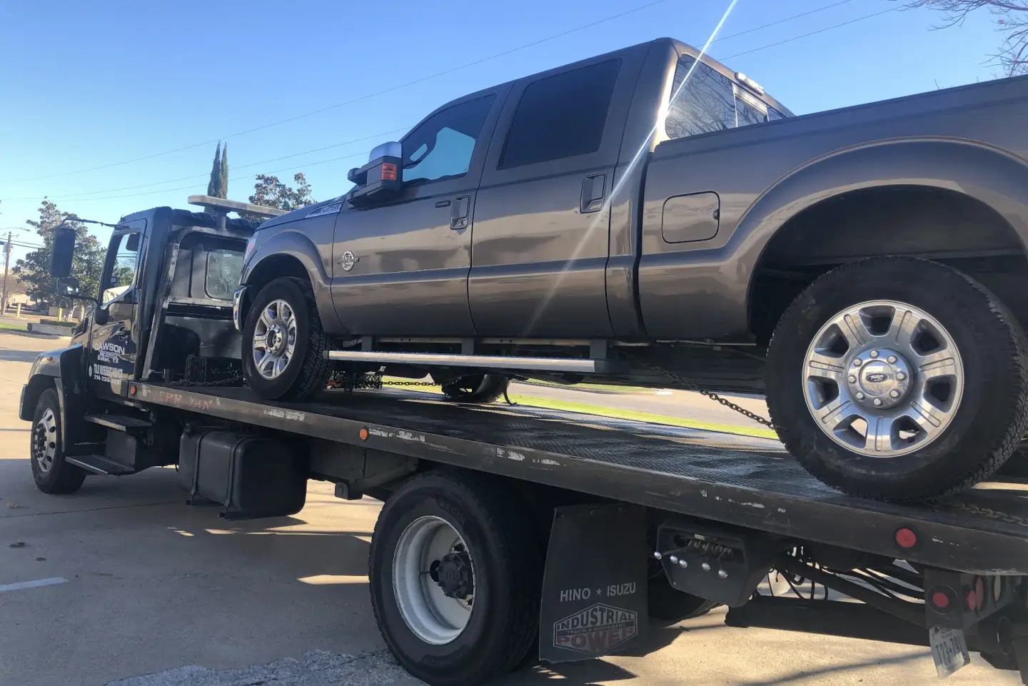 Ford F-250 on a Dawson Tow Service flatbed for long distance towing service in Dallas, TX